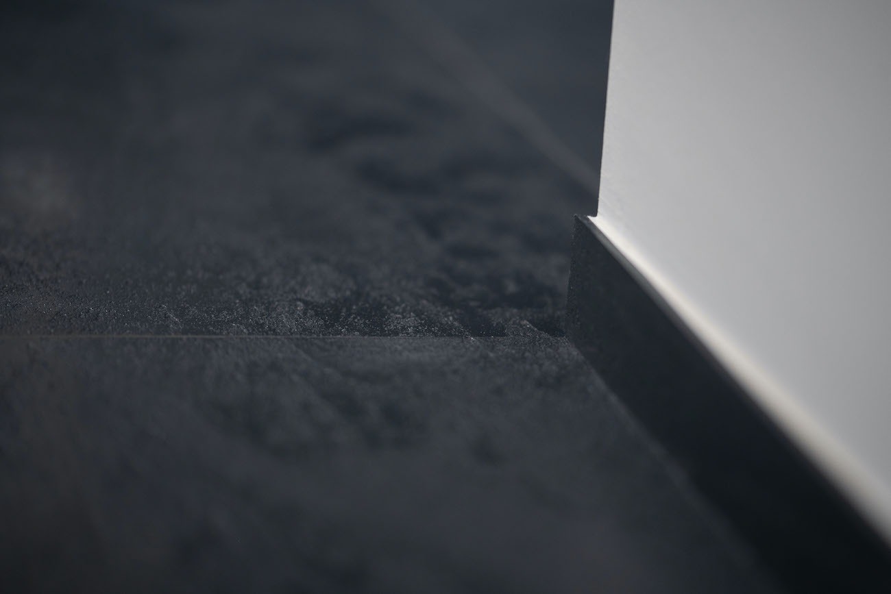 Die Bauherren haben sich bei der Designoberfläche wedi Top Line für die Farbe Carbon Schwarz entschieden, da diese an die alten belgischen Bleu-Steinfliesen erinnert. Der Überschuss an den Stirnseiten der wedi Top Oberflächenelemente wurde zu Sockelleisten zurechtgeschnitten und bildet so einen stilvollen Übergang vom Boden zur Wand.