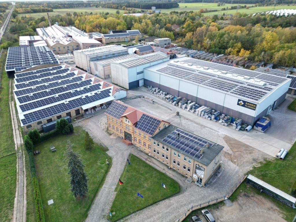 Werksgelände Zahna-Fliesen mit der fertiggestellten PV-Anlage, die mit11.000 Modulen auf 31.000 Quadratmetern Dachfläche zu den größten Dachflächenanlagen in Sachsen-Anhalt gehört. Foto: Zahna Fliesen